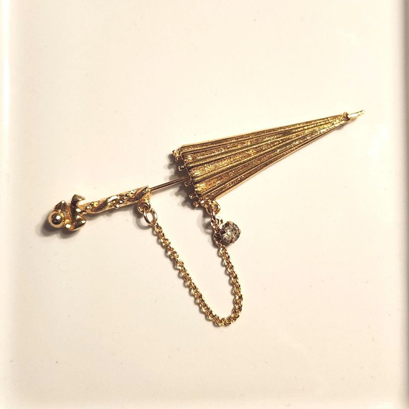 Lapel pins shaped like poodles, umbrellas, or fruit