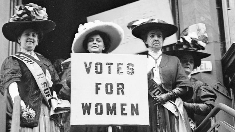 Women’s suffrage activists holding signs: “Votes for Women!” – 1920