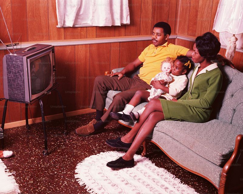Family Gathered Around a Television