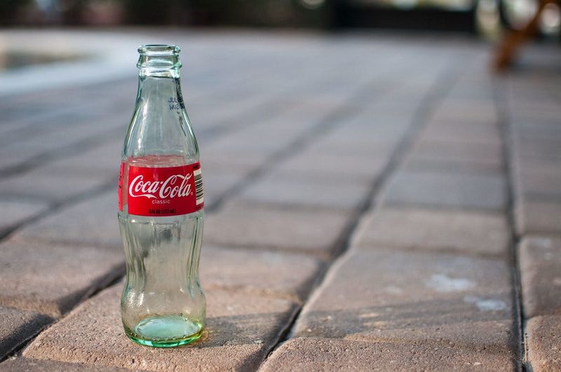 The fizzy psst of a soda being opened from a glass bottle