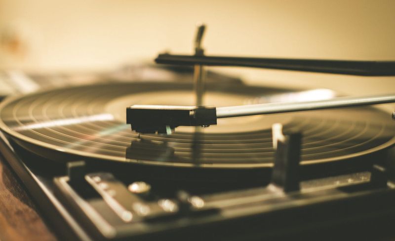 The needle drop and gentle crackle of a vinyl record starting up
