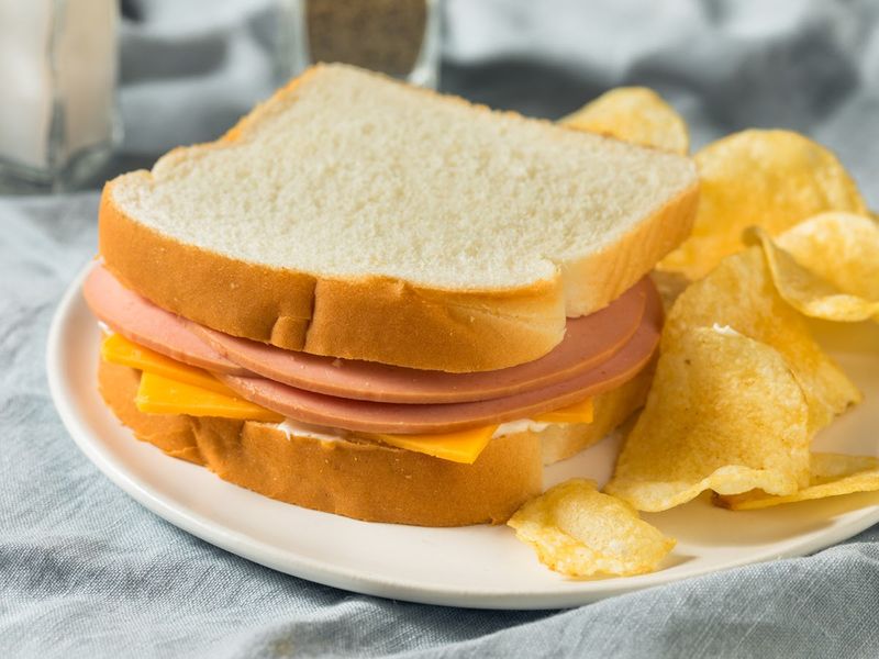 Packing sandwiches with white bread and bologna
